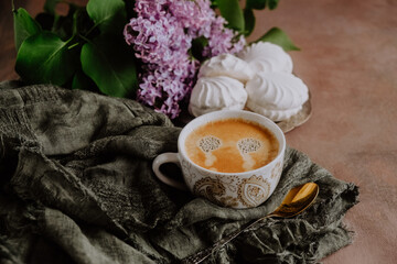 Coffee cup, zephyr and spring flowers. Romantic breakfast background. Coffee time.