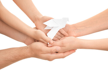 Hands of family with paper dove on white background