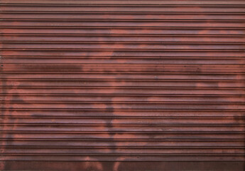 Vintage wall and door background metal texture of a hipster city street. Red texture worn of rust and vintage lines with character. Perfect wall for graffiti and street art.
