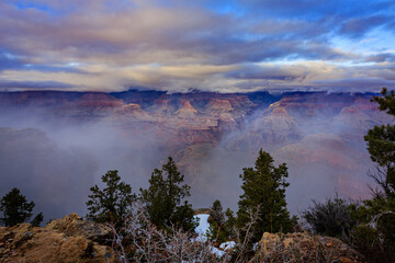 Mist flows through the Grand Canyon as seen from Mather Point of the South Rim of Grand Canyon National Park.