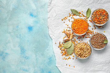 Bowls with lentils on color background