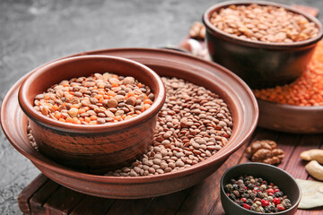 Different raw lentils with spices on table, closeup