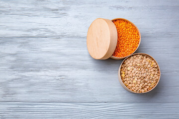 Boxes with raw lentils on table