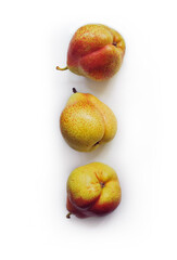 Yellow pears on a white background closeup