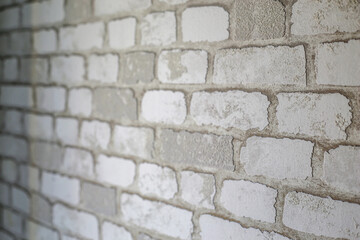 brick white wall for background. light and dark areas on the brick wall. professionally made brickwork on the wall.