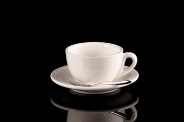 Empty white cup for coffee or tea on a dark background with reflection