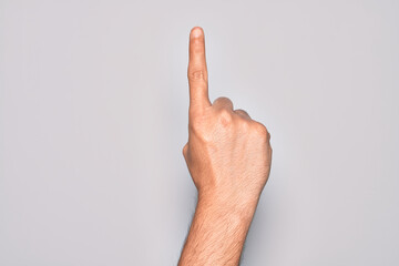 Hand of caucasian young man showing fingers over isolated white background counting number one using index finger, showing idea and understanding