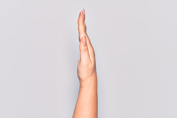 Hand of caucasian young woman showing the side of stretched hand, pushing and doing stop gesture