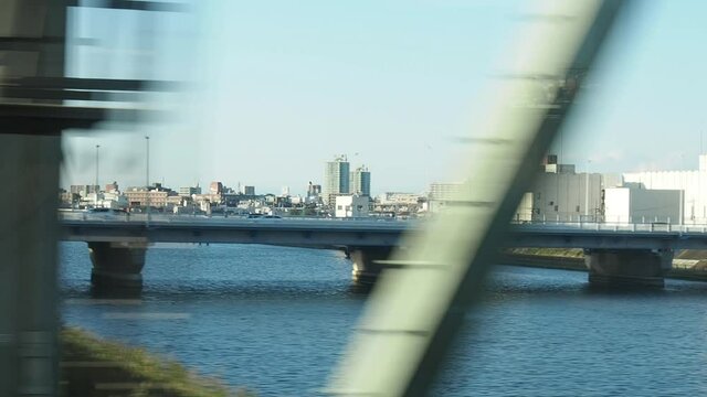 city view from window of moving train with motion blur . Video for mass transportation, travel and city life concept.
