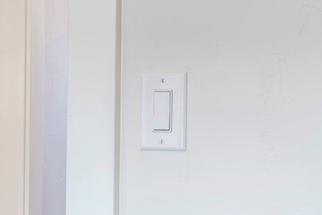 Indoor electrical light switch of home mounted on white wall background