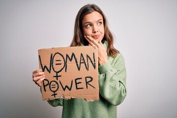Young blonde girl holding protest banner for woman power and rights over isolated background...