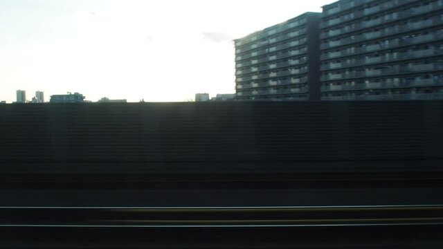 city view from window of moving train with motion blur . Video for mass transportation, travel and city life concept.