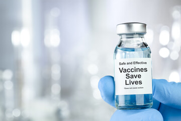 Healthcare concept with a hand in blue medical gloves holding a vaccine vial wtih the words Safe...