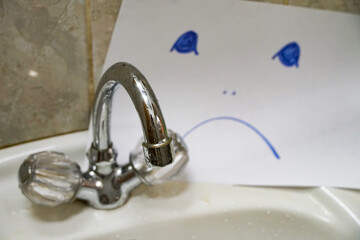 silver faucet in spray, unscrewing water supply, sad smile
