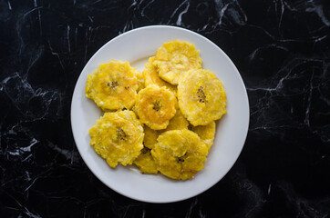 Fried plantain chips on a white plate