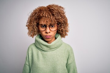 Young beautiful african american woman wearing turtleneck sweater and glasses skeptic and nervous, frowning upset because of problem. Negative person.