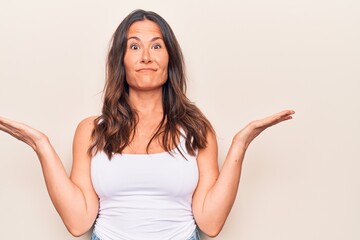 Fototapeta premium Young beautiful brunette woman wearing casual t-shirt standing over isolated white background smiling with happy face winking at the camera doing victory sign. Number two.