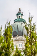 Majestic dome of Utah State Capital Building with blurry trees in the foreground