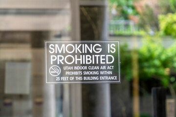 Smoking is Prohibited sign close up on clear glass door of building in Utah