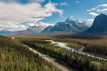 Aerial view of vehicles on scenic Icefields Parkway highway between Banff and Jasper National Parks during summer in Alberta, Canada. - obrazy, fototapety, plakaty