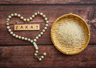 ZAKAT (islamic tax) text on wooden table. Islamic zakat concept. Selective focus.