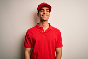 Young handsome african american man wearing casual polo and cap over red background with a happy...