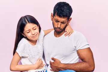 Latin father and daughter wearing casual clothes relaxed with serious expression on face. simple and natural looking at the camera.
