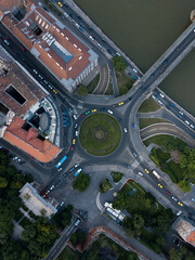 
Aerial view of roundabout city traffic near Szechenyi Chain Bridge and Parliament building. Cars drive on circle road and riverside road. Historic architecture buildings. Budapest, Hungary, Europe
