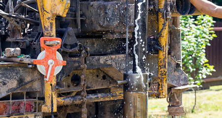 Drilling rig, drill pipe lifting. A fountain of water pours out of the pipes. Strength and energy