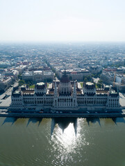 Fototapeta premium Aerial footage of Parliament of Budapest, Hungarian parliament building on the riverside of Danube. Orszaghaz, Budapest city, Hungary, Europe. Summer. Neo gothic architecture. Travel destination 
