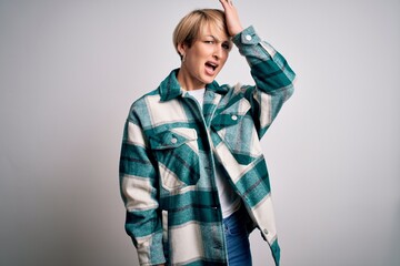 Young blonde woman with short hair wearing casual retro green shirt over isolated background...