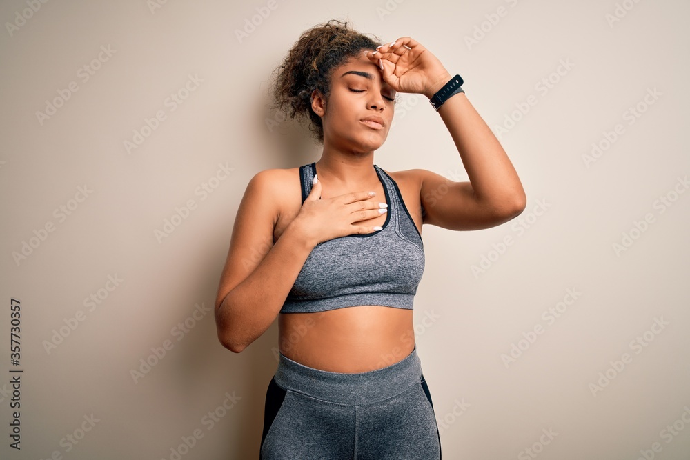 Poster Young african american sportswoman doing sport wearing sportswear over white background Touching forehead for illness and fever, flu and cold, virus sick