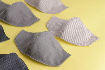 flat lay design of fashion face mask handmade from fabric cloth on yellow background