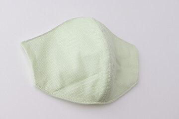 green cloth mask design made from cotton fabric, object on white background