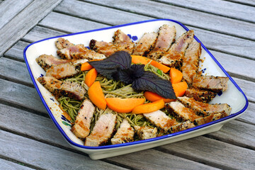 Dish of soba noodles with seared tuna, apricot and purple shiso leaves