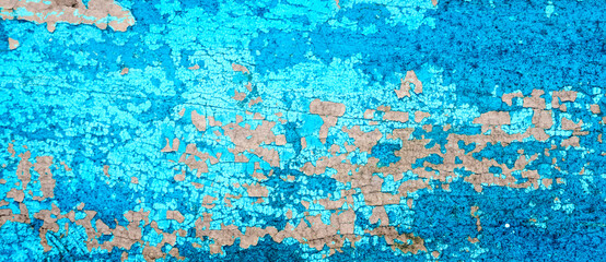 Old crackled teal turquoise painted wood surface. Vintage wooden wall or floor with cracked paint.