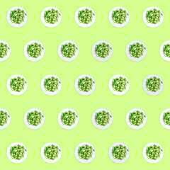 Pattern of plates with lightly fried brussels sprouts on the neon green drop. Easy cooking, healthy...