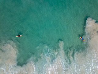 Aerial View With Surfers And Barrel Wave In Ocean