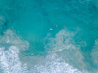 Aerial View With Surfers And Barrel Wave In Ocean