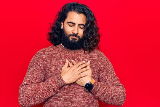 Young arab man wearing casual clothes smiling with hands on chest, eyes closed with grateful gesture on face. health concept.