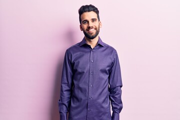 Obraz premium Young handsome man with beard wearing casual shirt with a happy and cool smile on face. lucky person.