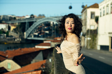 Fototapeta premium Asian woman on a street in old Porto downtown. Portugal.