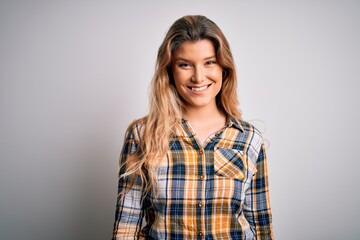 Fototapeta premium Young beautiful blonde woman wearing casual shirt standing over isolated white background with a happy and cool smile on face. Lucky person.