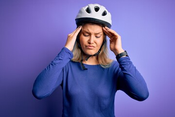 Young beautiful blonde cyclist woman wearing bike security helmet over purple background suffering from headache desperate and stressed because pain and migraine. Hands on head.
