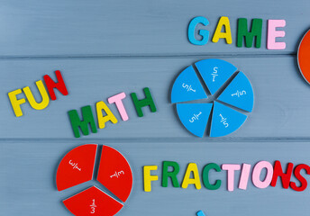 Close up mathematical fractions and colorful letters on gray background. Creative, fun mathematics banner. Education, back to school concept	