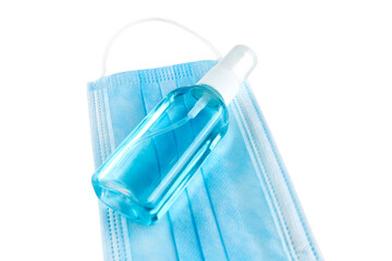 Blue medical face mask and antiseptic spray isolated on white background