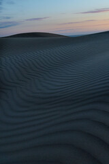 Fototapeta na wymiar Ripples on sand dunes at dusk