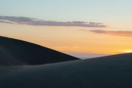 View of sand dunes during sunrise