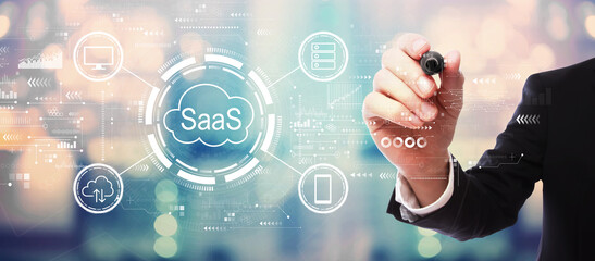 SaaS - software as a service concept with businessman on blurred abstract background