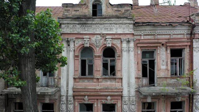 Abandoned old manor (mansion) house (mansion) in the neoclassical style with an abundance of decor and broken windows. Deserted building of the 19th century. Aerial side view